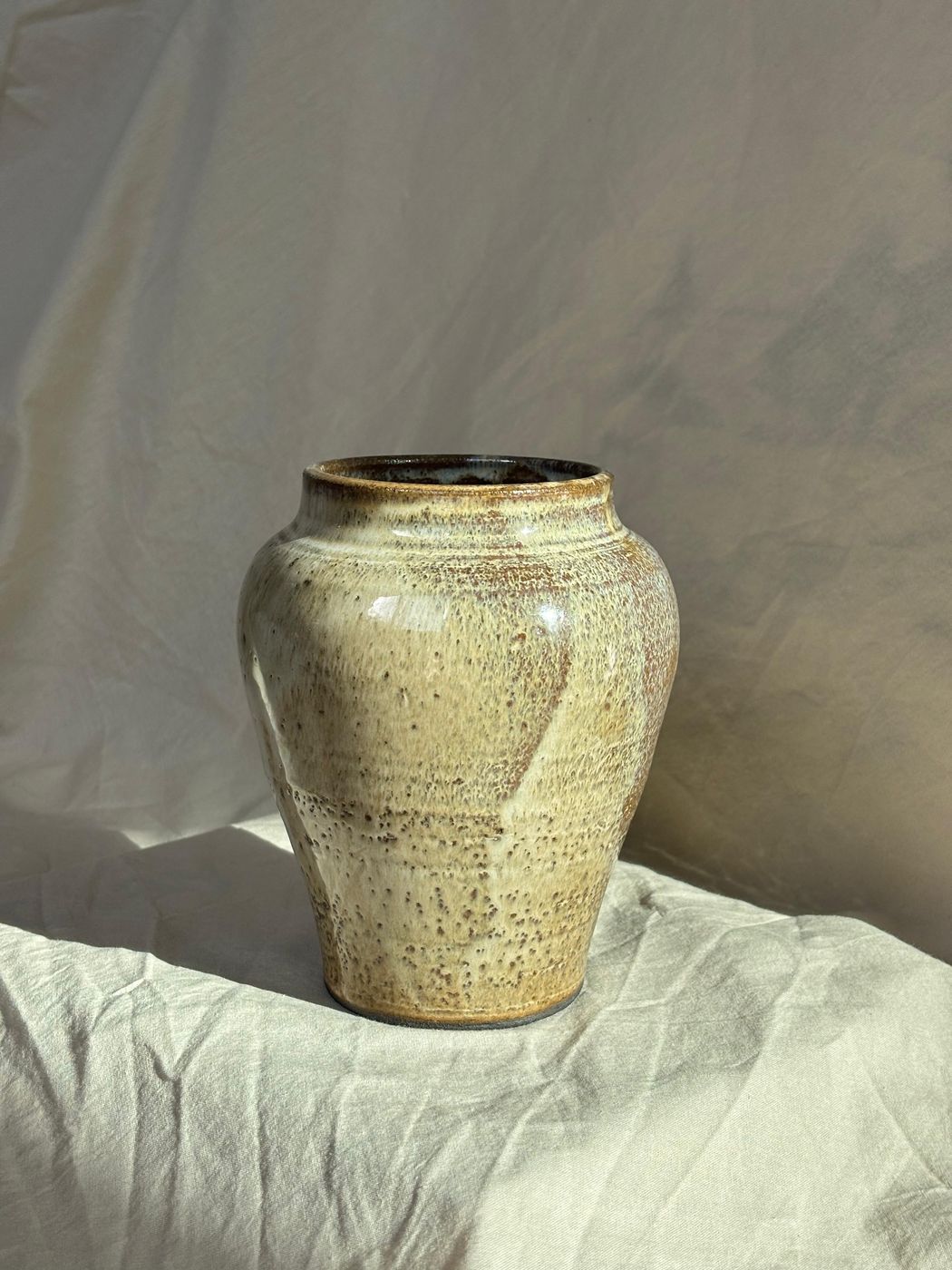 Speckled stoneware vase, tan and cream glaze