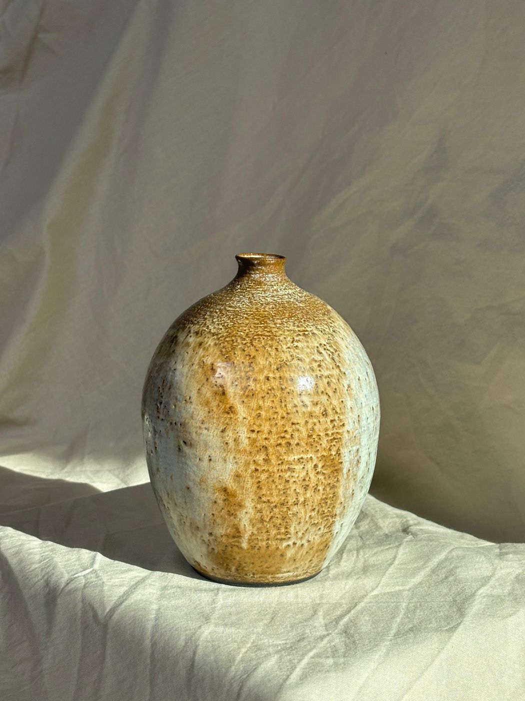 Wide-necked stoneware vase, tan and cream glaze