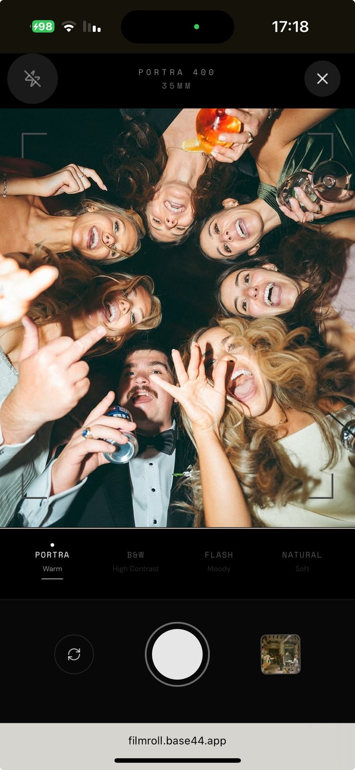 FilmRoll camera screen with a Portra 400 film stock, framing a group photo mid-shot